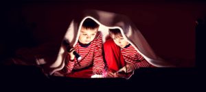 Kids reading with flashlights